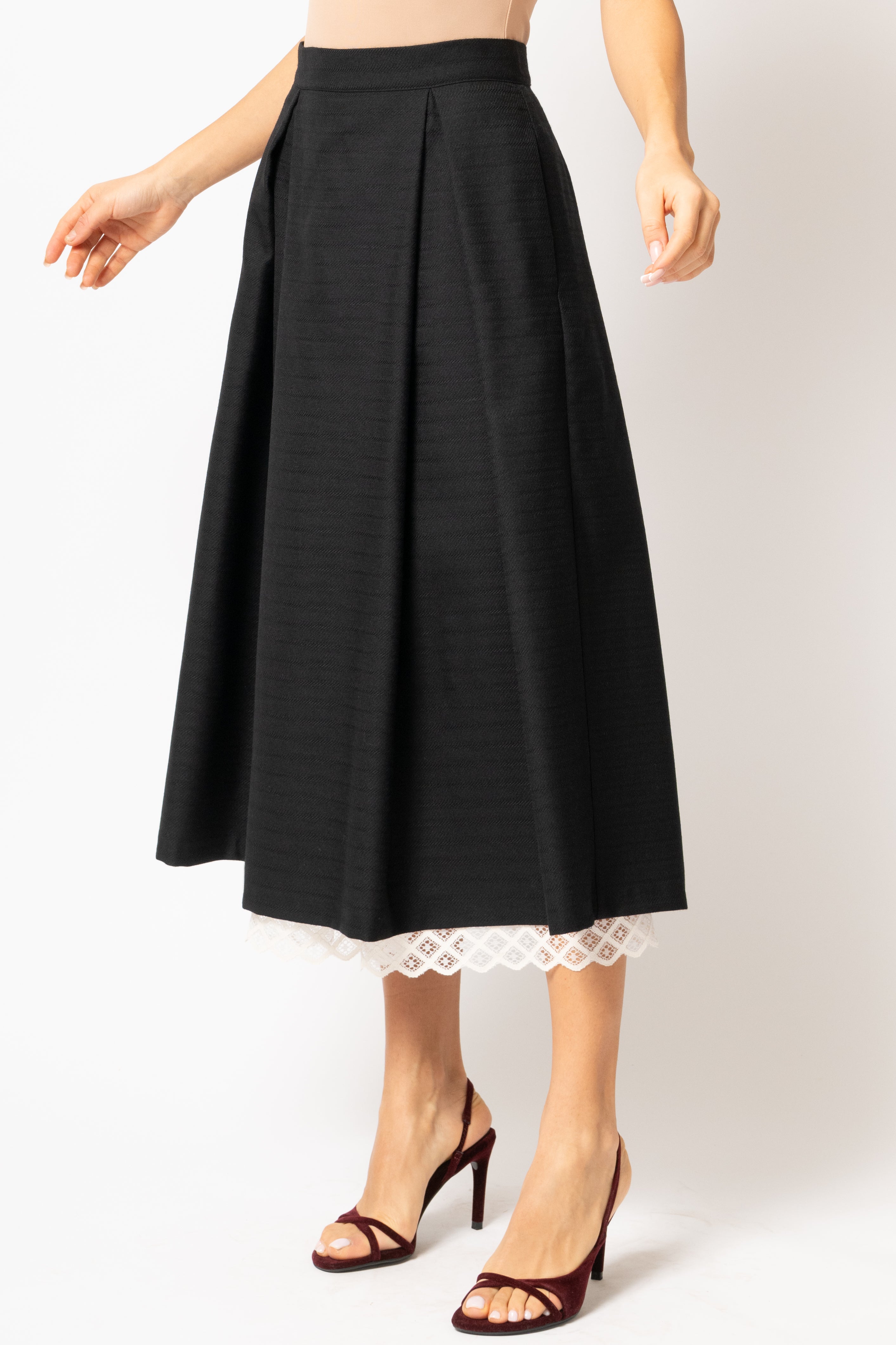 Wide midi skirt made of black wool fabric with ecru lace