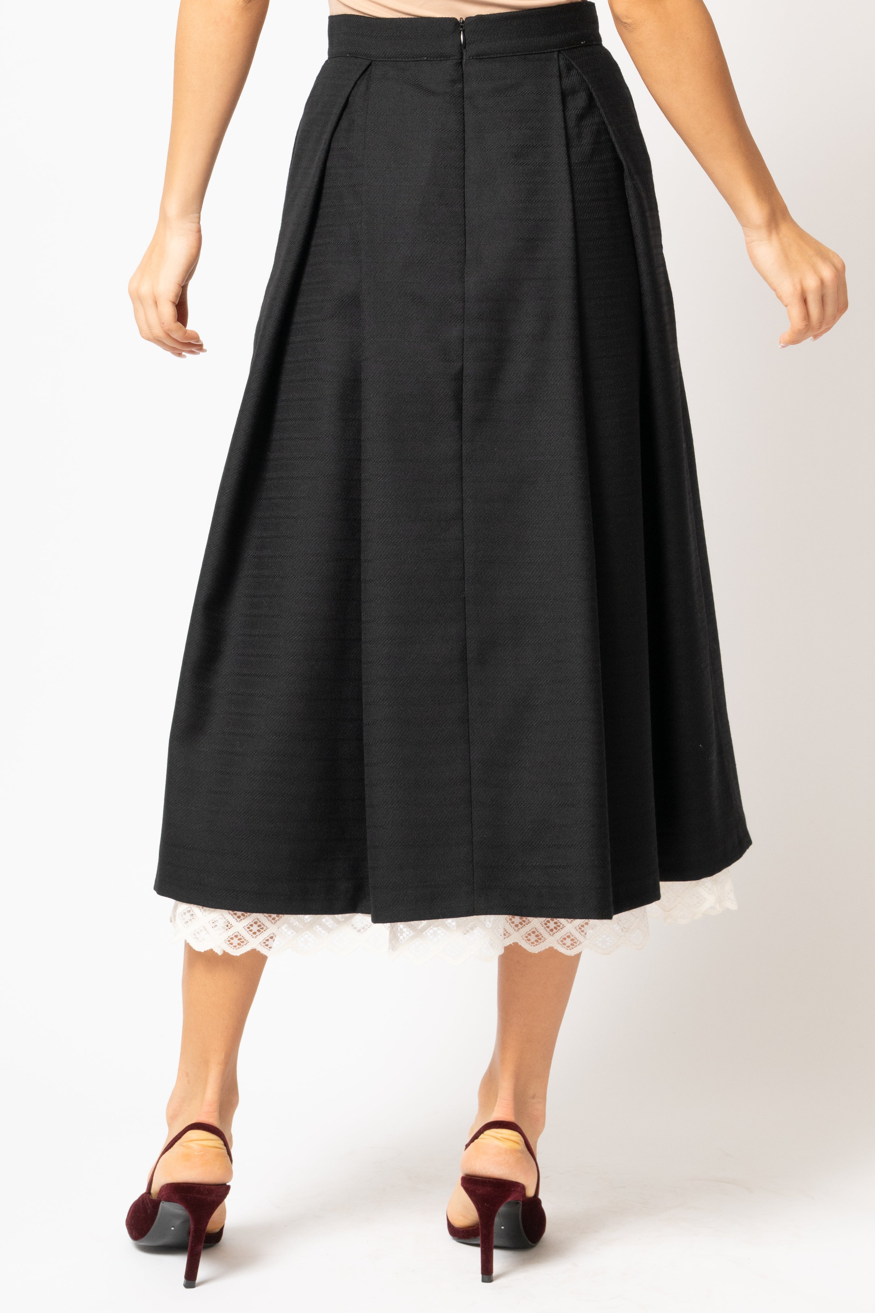 Wide midi skirt made of black wool fabric with ecru lace