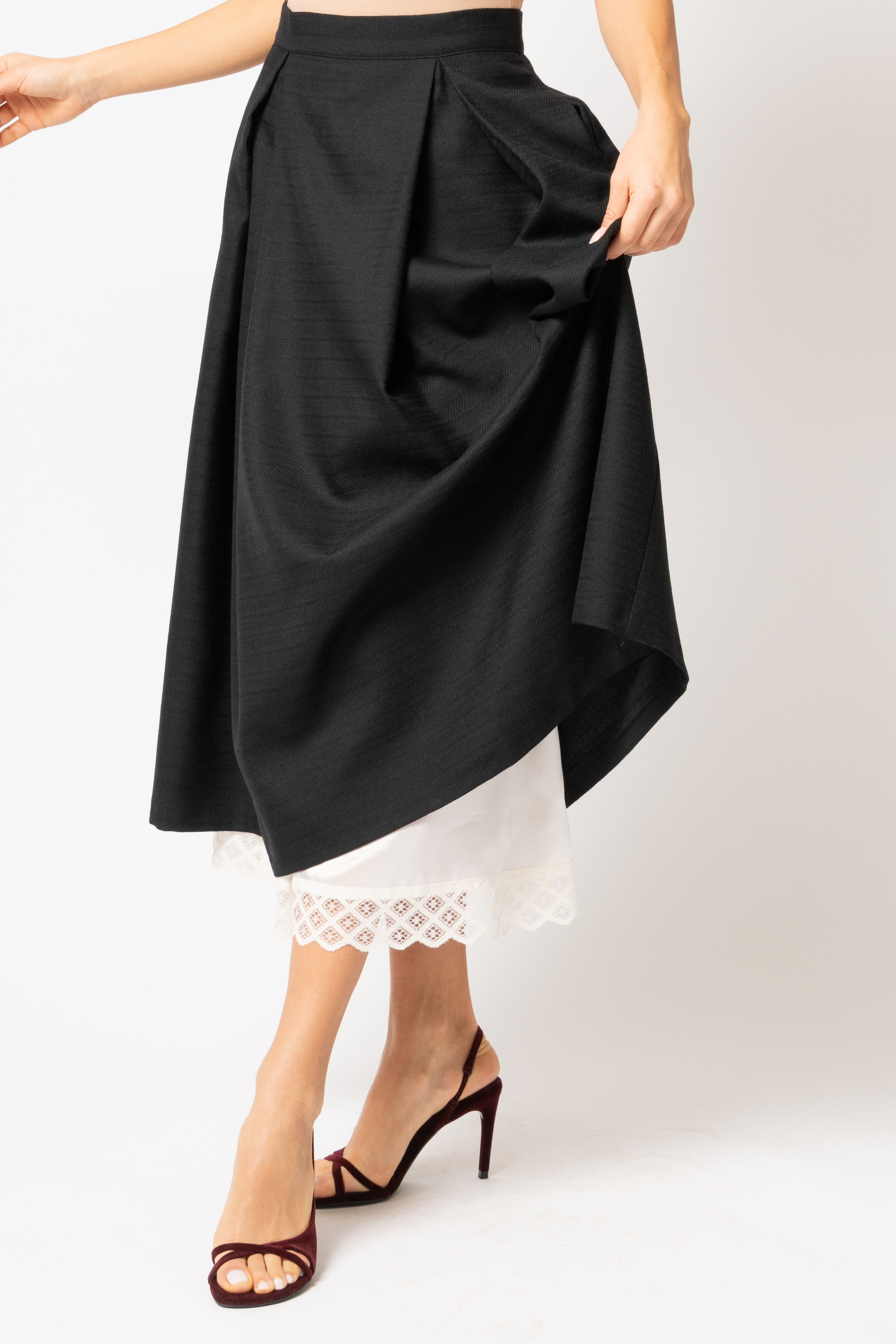 Wide midi skirt made of black wool fabric with ecru lace