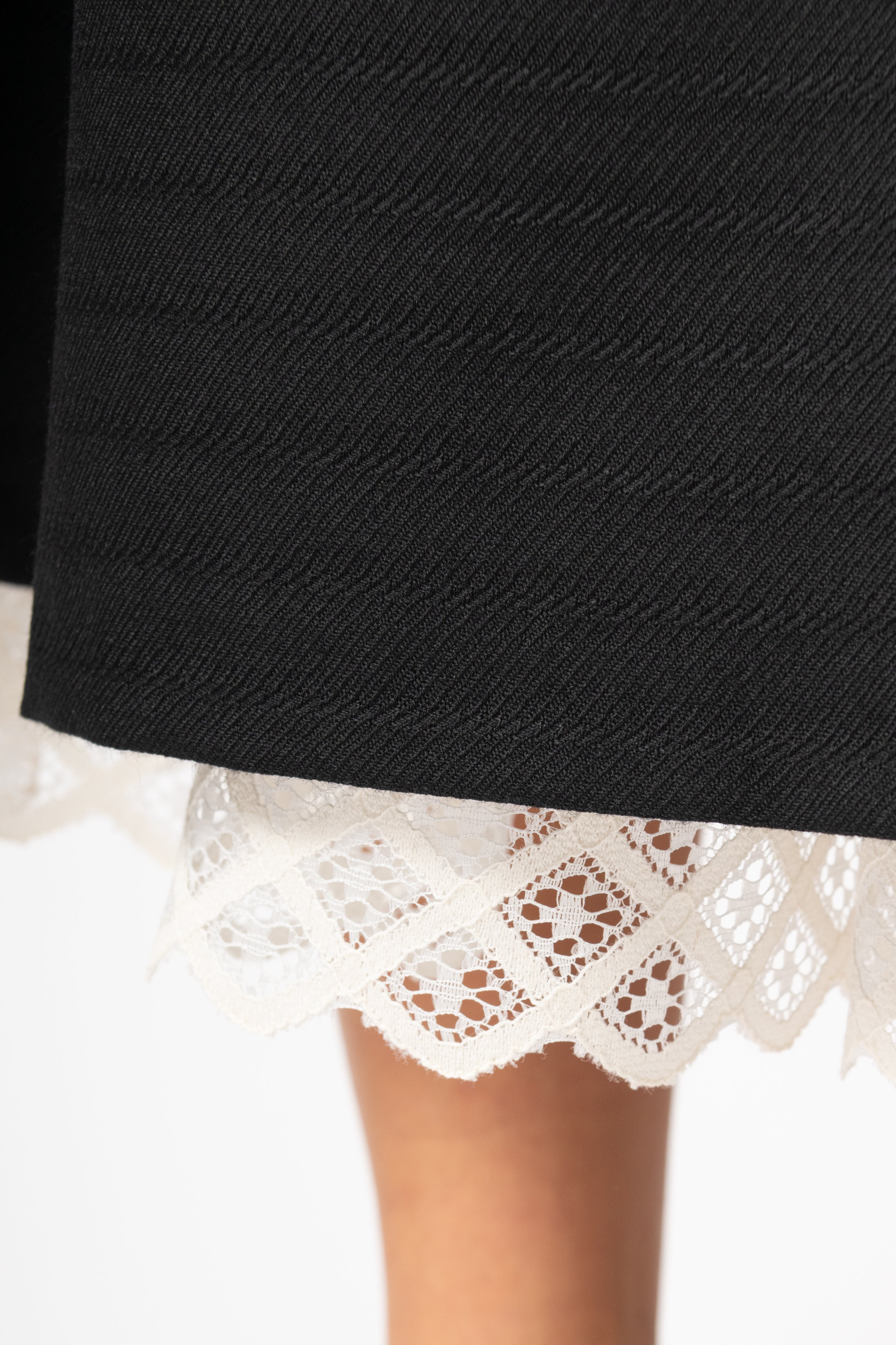 Wide midi skirt made of black wool fabric with ecru lace