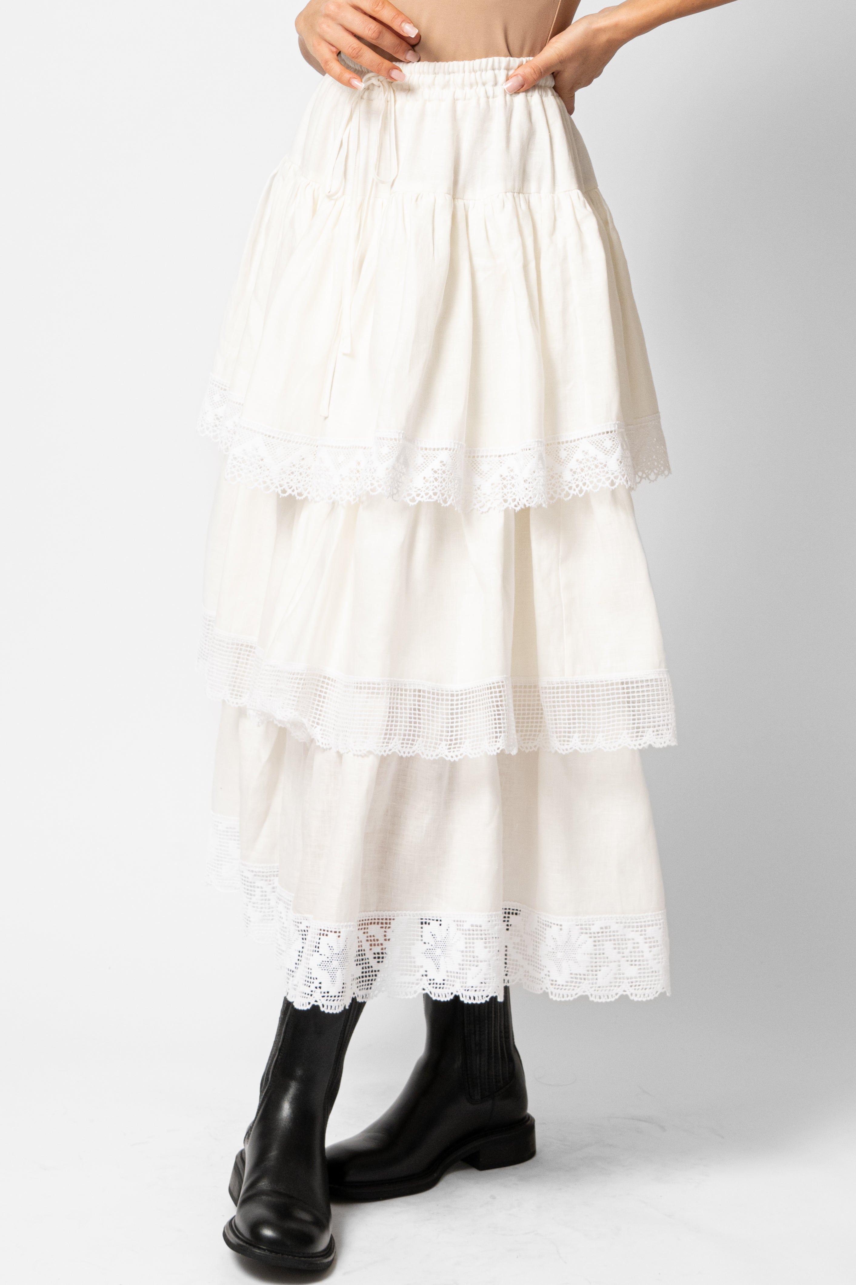 White linen midi skirt with ruffles and crocheted lace