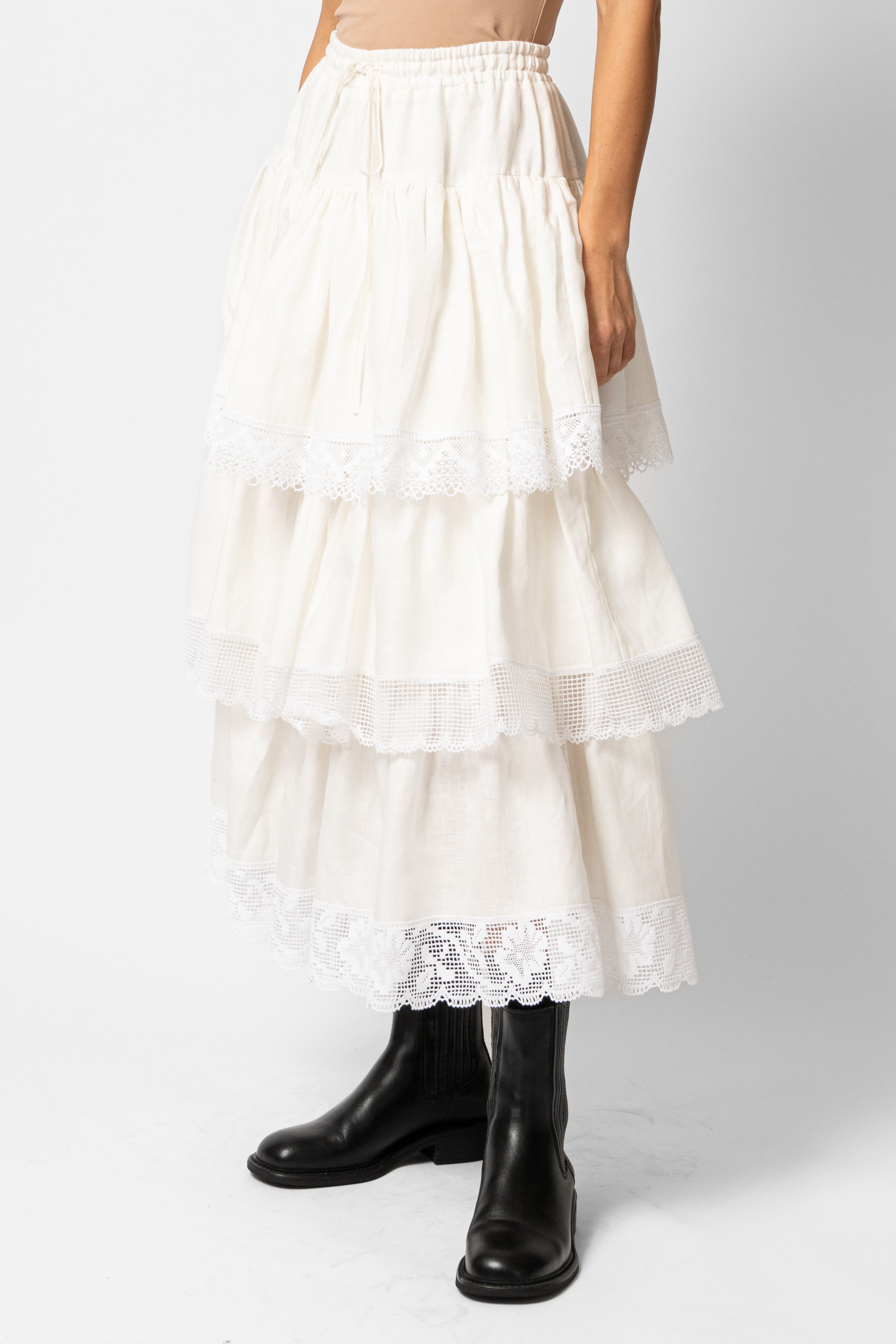 White linen midi skirt with ruffles and crocheted lace