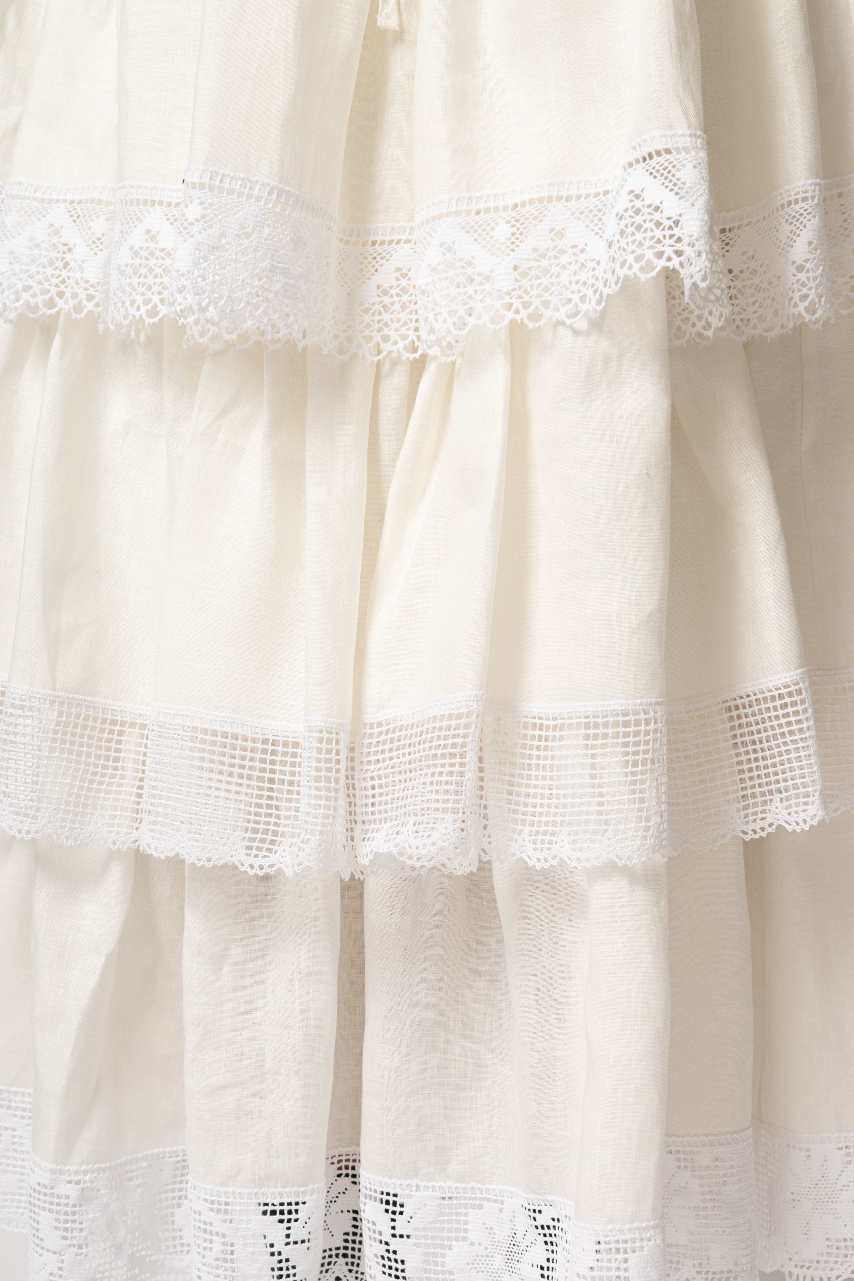 White linen midi skirt with ruffles and crocheted lace
