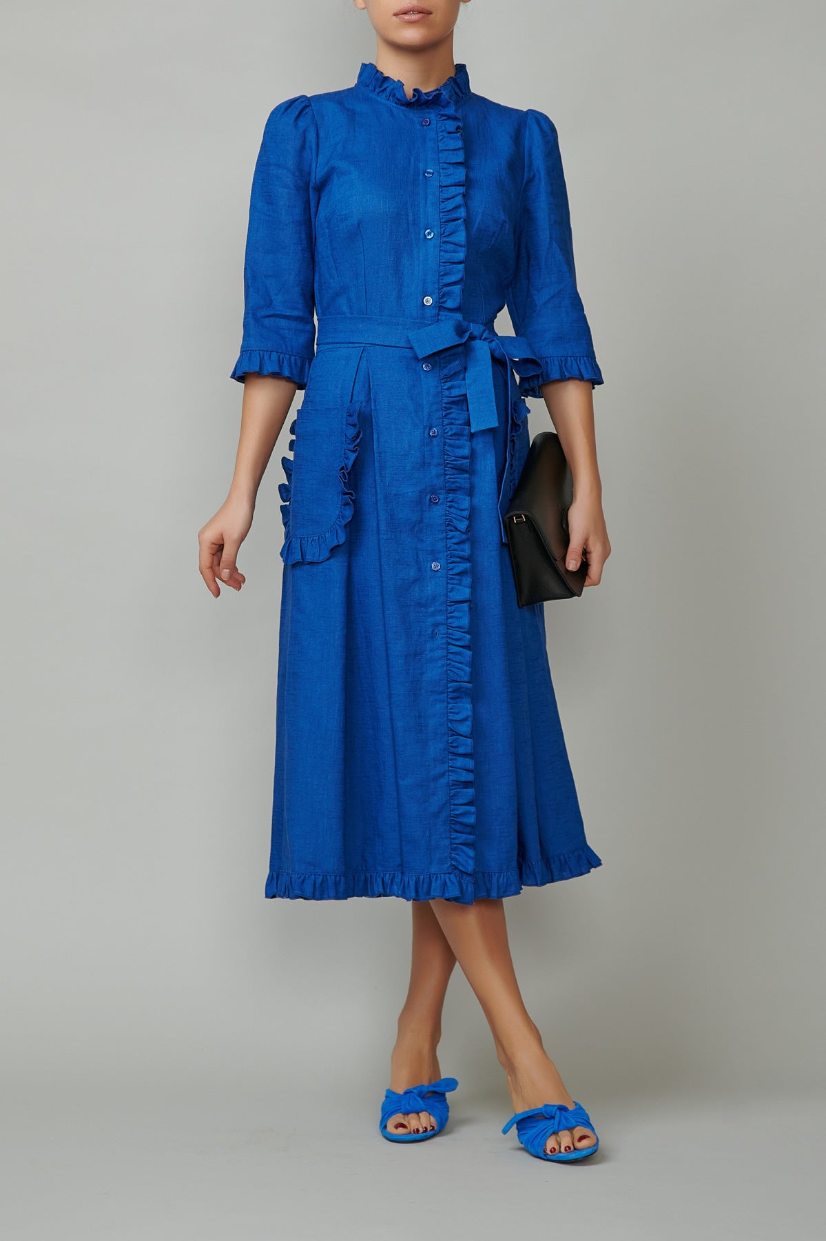Blue linen shirt dress with applied pockets and ruffles