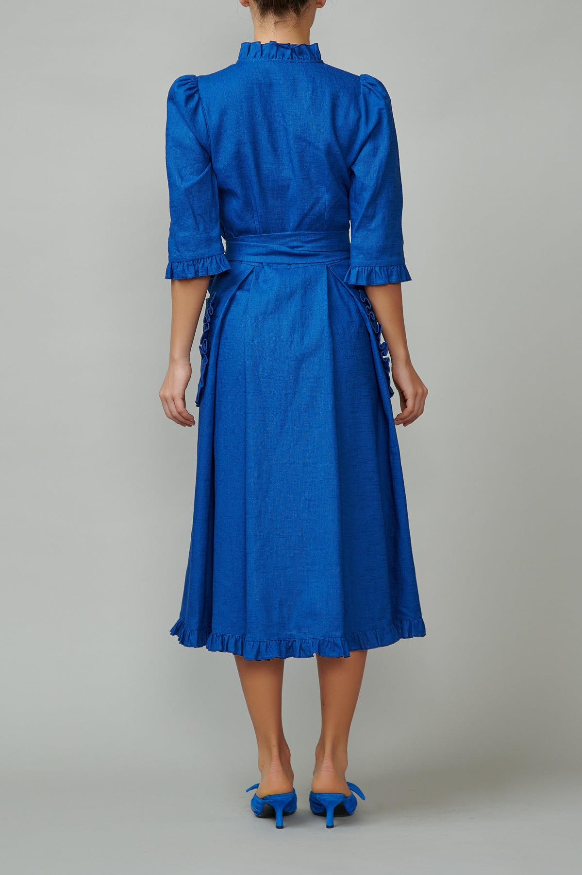 Blue linen shirt dress with applied pockets and ruffles