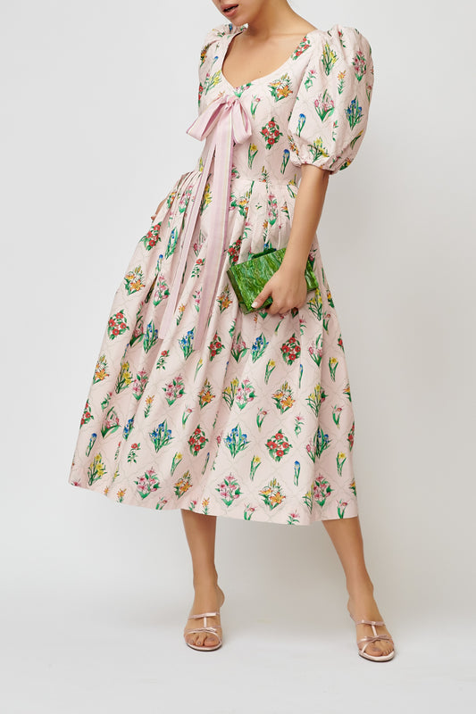 Cotton dress with multicolored flower print on a pink background